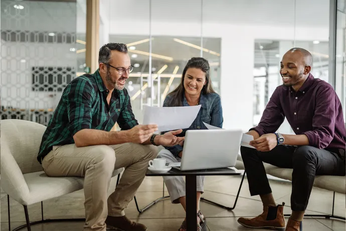 Two men and a woman sat in a meeting.